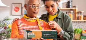 Grandmother and granddaughter reading back of ZENB Spaghetti box